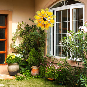 yard windmills spinners metal in yellow color like like a beautiful flower