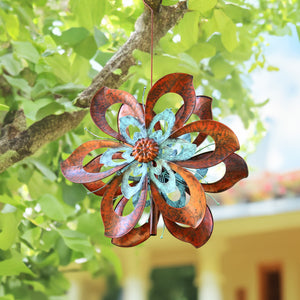 Metal wind sculpture hanging on the tree, copper color flowers
