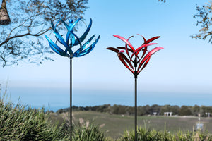 Blue lotus wind spinners and Crimson Magnolia wind sculptures in the garden
