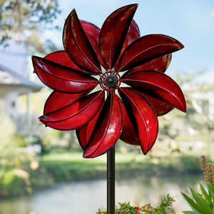 Shiny dark red wind spinner in a shape of a flower
