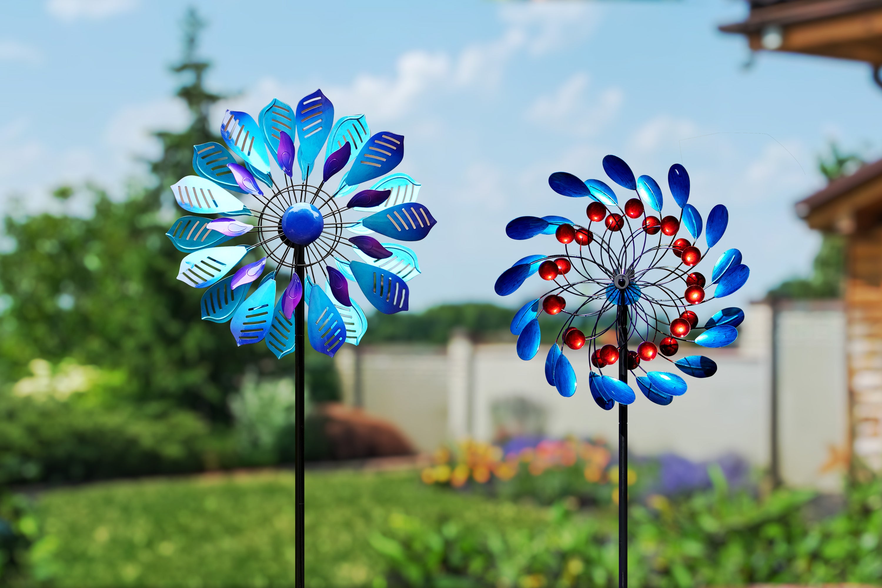 Two brightly colored pinwheels spin in the garden, adding energy and movement to the tranquil, natural backdrop.