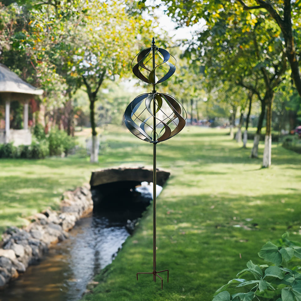 Heavy duty steel wind spinner stand around a river, the patio full of tree, so beautiful