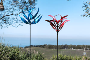 Blue lotus wind spinners and Crimson Magnolia wind sculptures in the garden